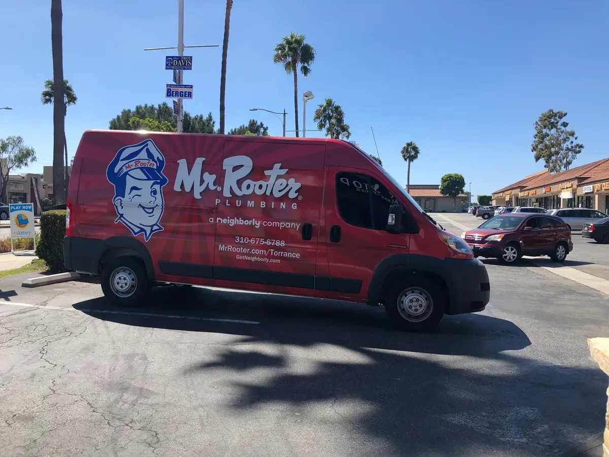 A Mr. Rooter service van arriving on-site for a scheduled plumbing appointment in a Torrance neighborhood.